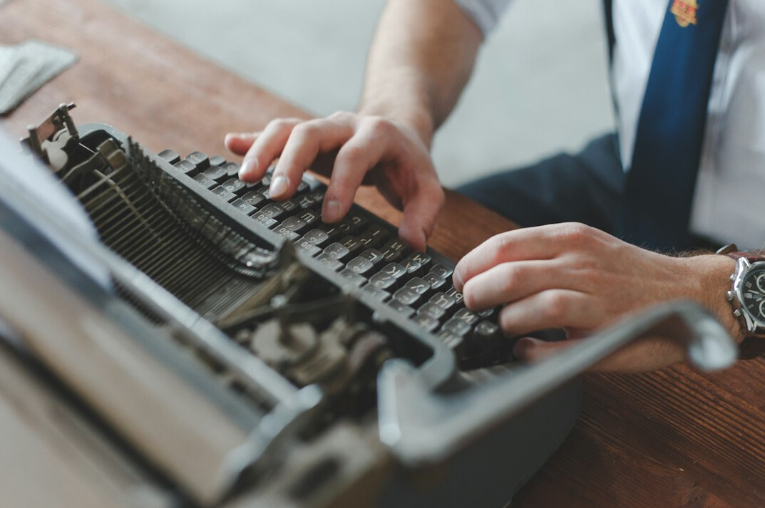 writer at desk with notebook