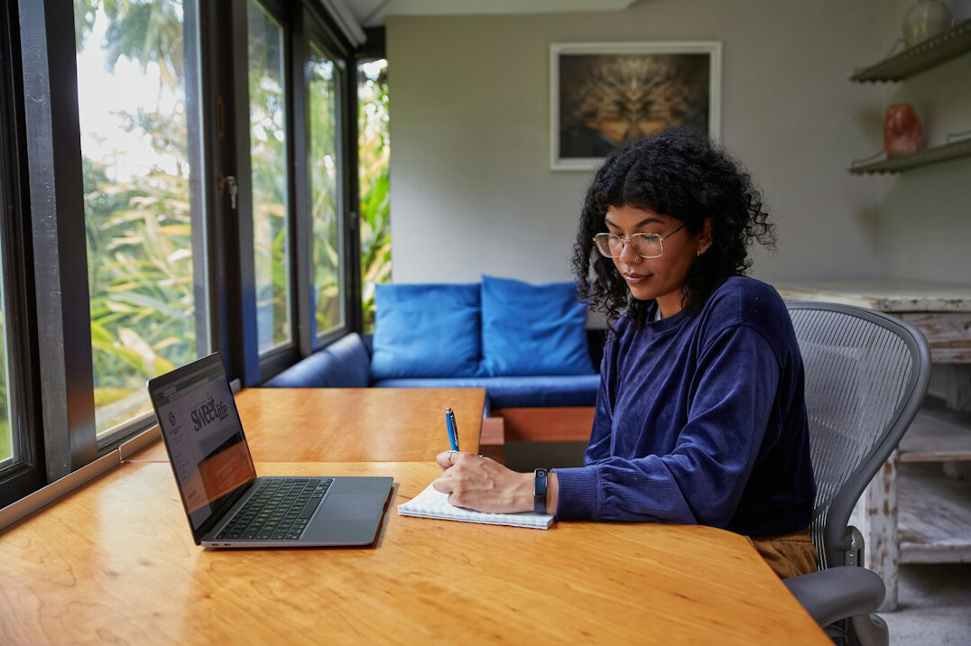 writer at desk with notebook